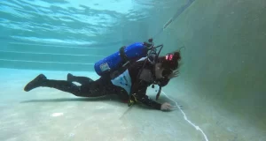 Inspecting a Swimming Pool Leak with Scuba Diving Gear