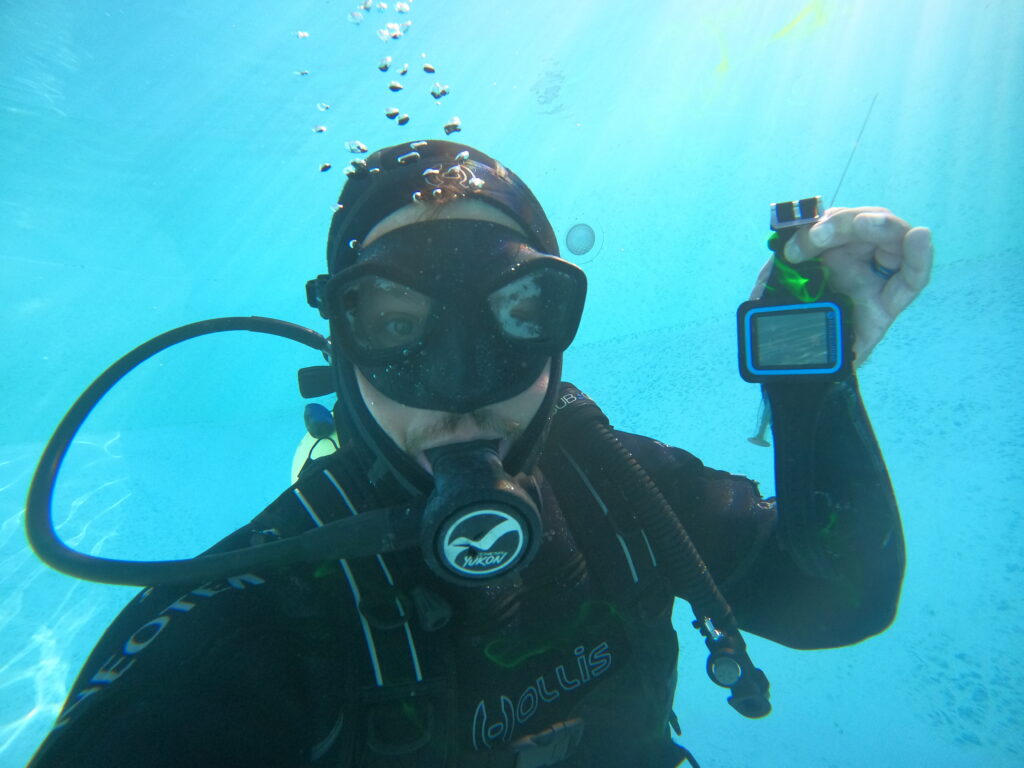 NAUI-certified Aquatrace diver performing underwater pool leak detection inspection — professional cold water dive safety protocols in practice
