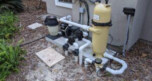 Pool pump and filtration equipment pad at a residential swimming pool — the starting point for pump-on vs. pump-off leak detection testing