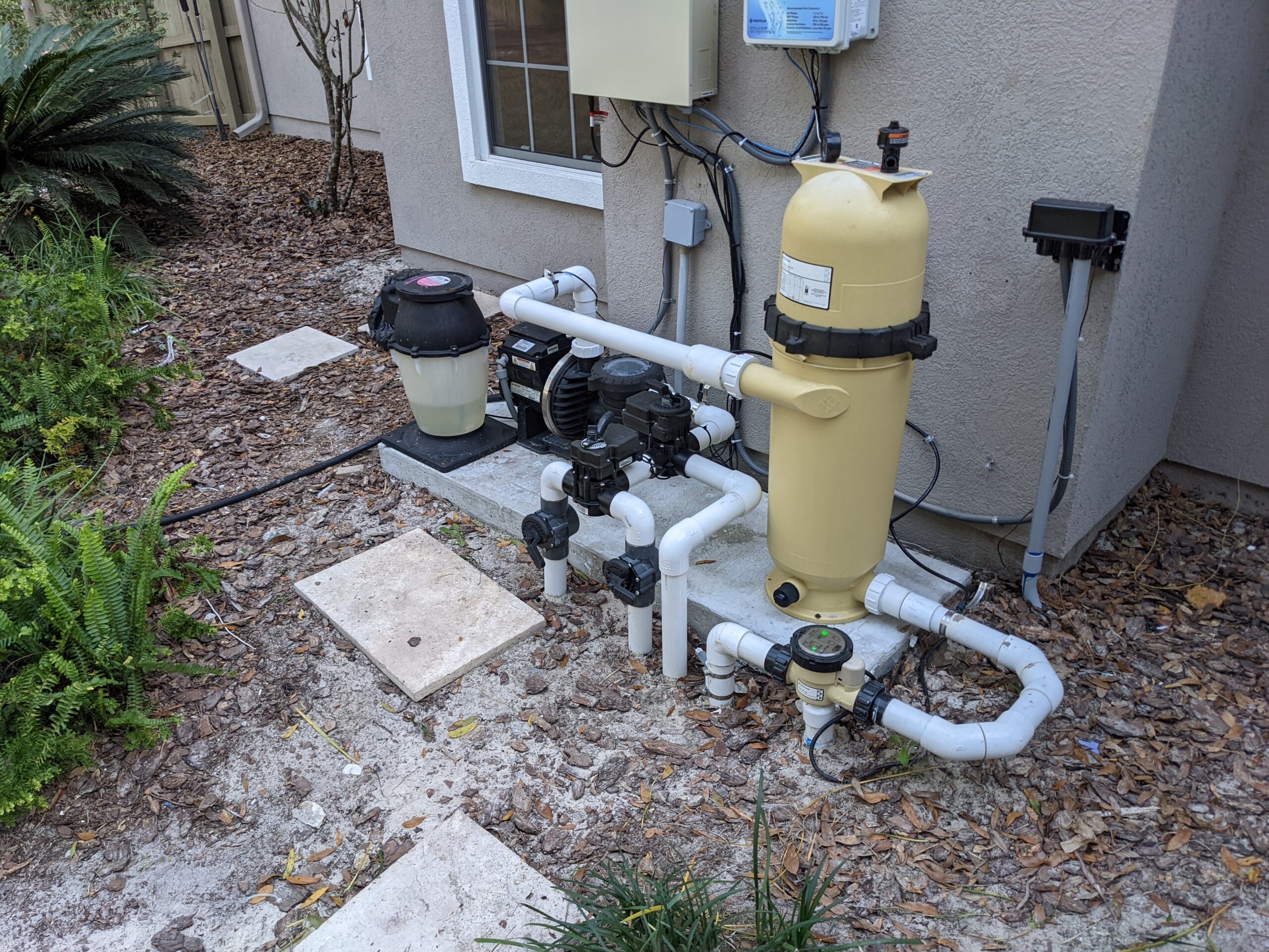 Pool pump and filtration equipment pad at a residential swimming pool — the starting point for pump-on vs. pump-off leak detection testing