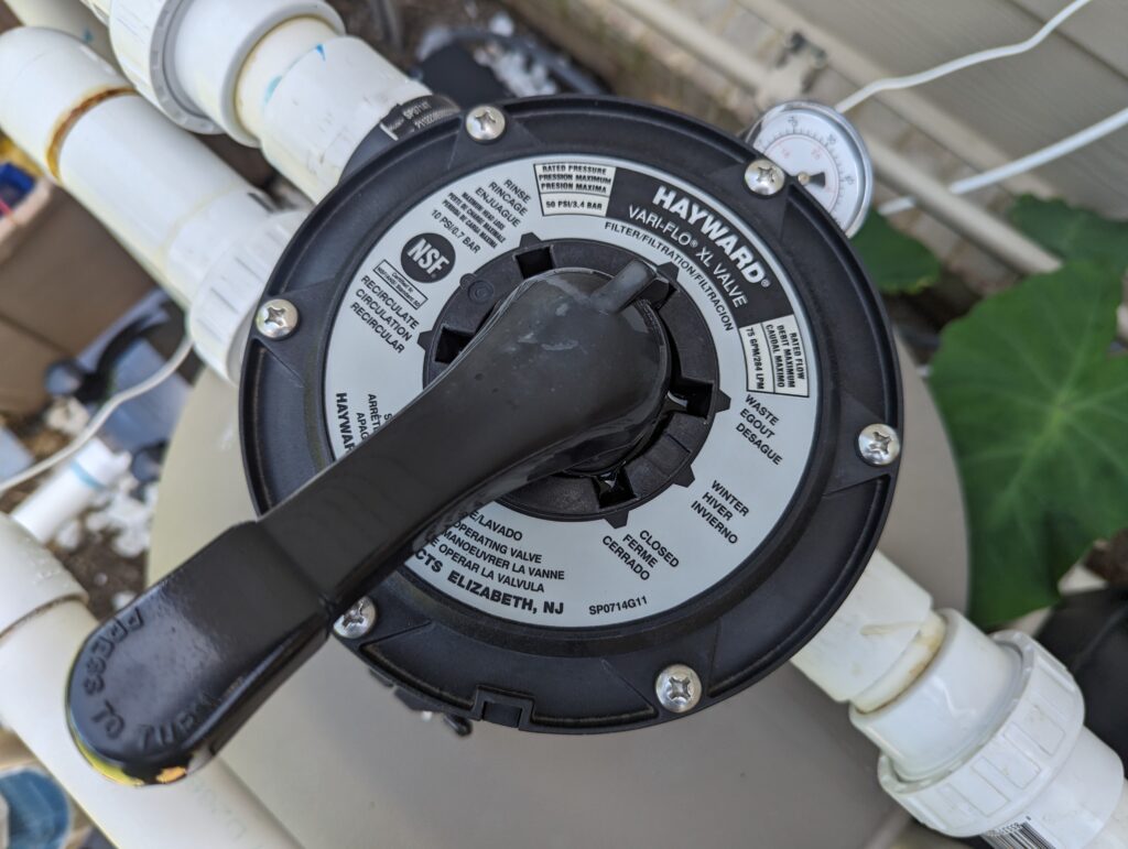 Pool multiport backwash valve on a residential filter system — a common source of pressure-side water loss when the pump is running